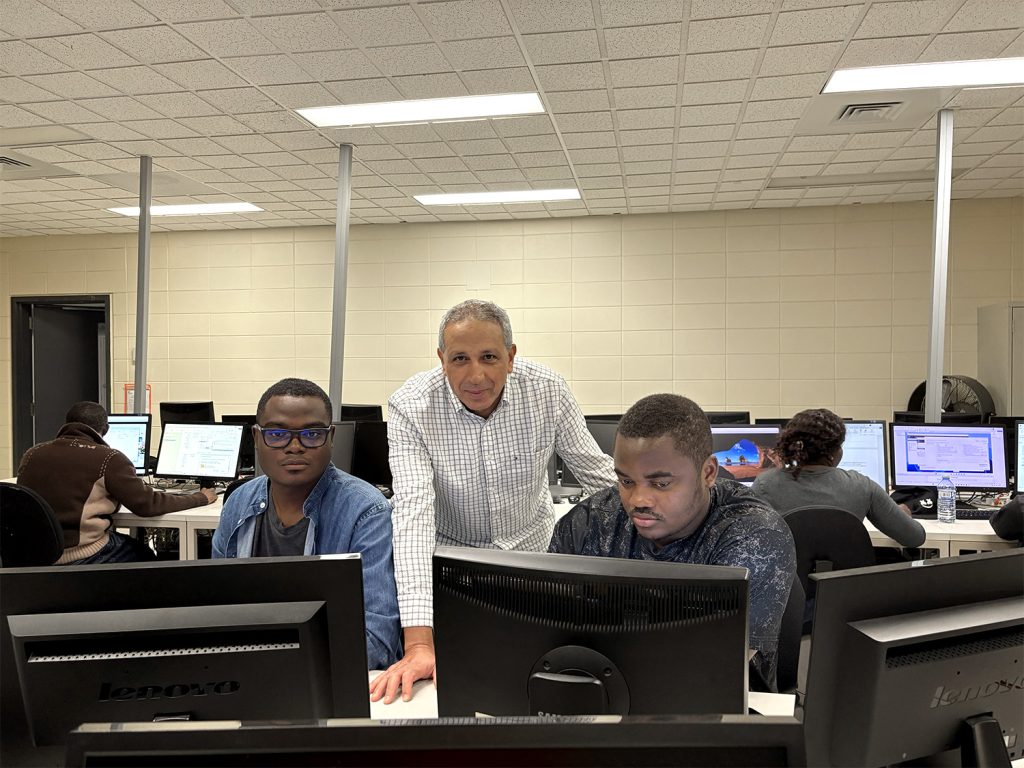 Une enseignant aide ses étudiants, en classe